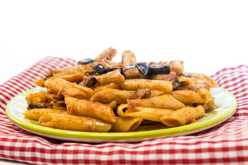 Pasta with aubergine and tomato sauce on a the table