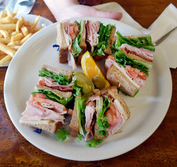 Basic club sandwich on white plate.