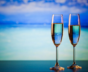 two champagne glasses on the beach - exotic New Year