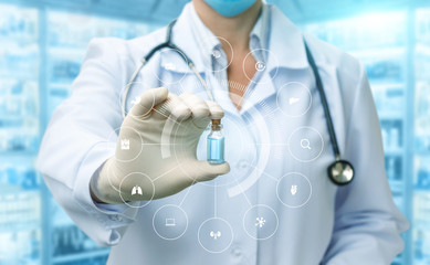 Doctor shows a tube of vaccine .