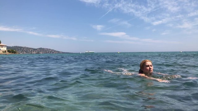 Blue French coast water swimming slow-mo footage - Caucasian woman in crystal clear sea slow motion