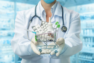 Shopping cart of tablets in the hands of the pharmacist .