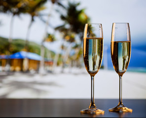 two champagne glasses on the beach - exotic New Year