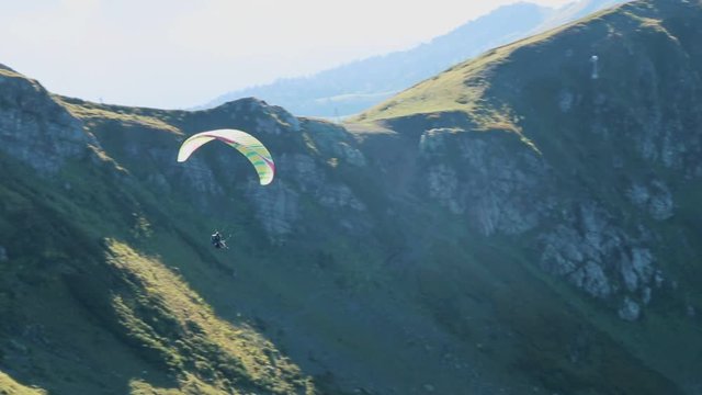 Flying Paraglider on a Background of the Sun and Beautiful Clouds