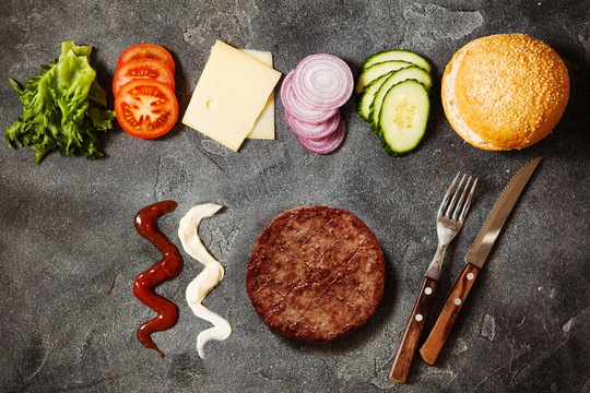 Homemade Hamburger With Ingredients On Dark Slate Background Top View