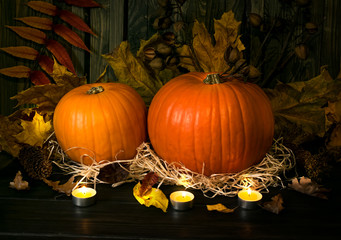 Festive still life with pumpkins and burning candles for Thanksgiving