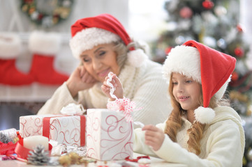 Grandmother and granddaughter preparing for Christmas
