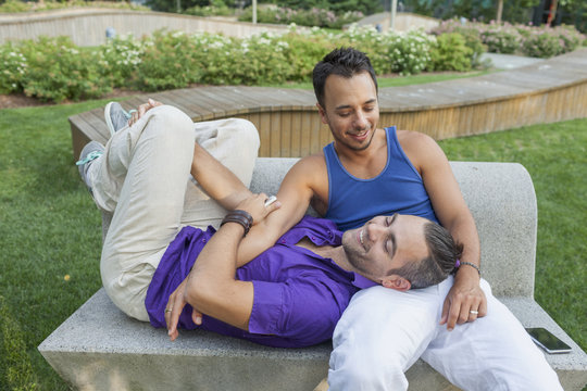 Gay couple sitting on a bench together