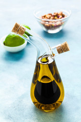 cruet with olive oil and balsamic vinegar on a blue board