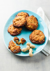 cookies with peanut butter and jam on a blue plate on a white stone background