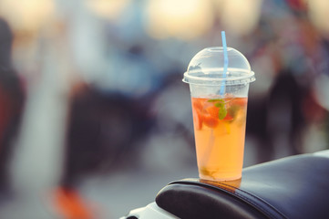 drink strawberry punch in a plastic glass on the street