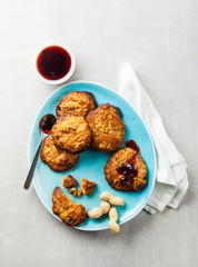 cookies with peanut butter and jam on a blue plate on a white stone background