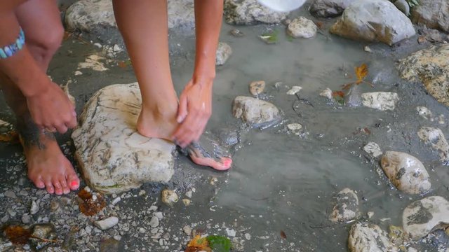 Woman smearing mud on the body