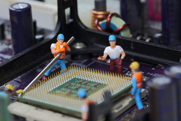Selective focus of miniature engineer, worker break CPU fixed and repair CPU processor,  mainboard computer and use for business background.