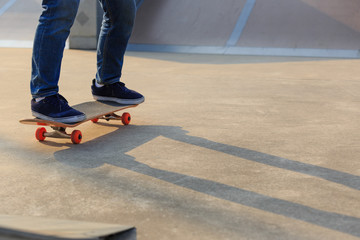 skateboarder legs skateboarding on skatepark