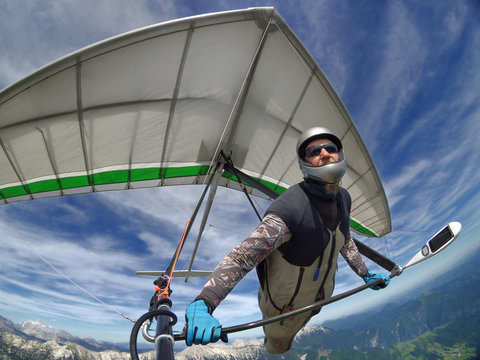 Selfie shot of  hang glider pilot soaring the thermal updrafts