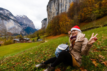 Naklejka na ściany i meble girl in a Santa Claus hat in the mountains