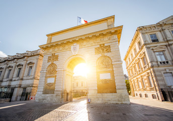 Fototapeta na wymiar Street view with Triumphal Arch during the sunrise in Montpellier city in Occitanie region of France