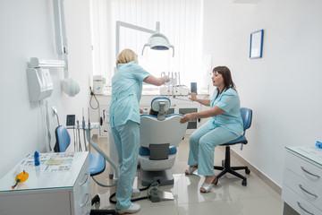 Little girl sitting in the dentists office