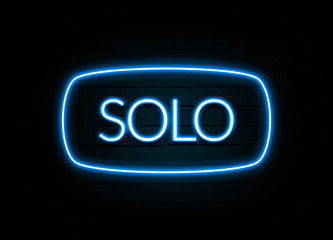 Solo  - colorful Neon Sign on brickwall