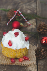 Cream cupcake and pomegranate.