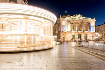Night view on the Comedy square with Opera building and carousel in Montpellier city in southern...