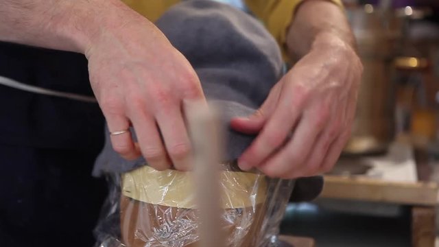 Hat-maker in works