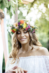 Groom put on a ring to bride's finger during wedding ceremony.