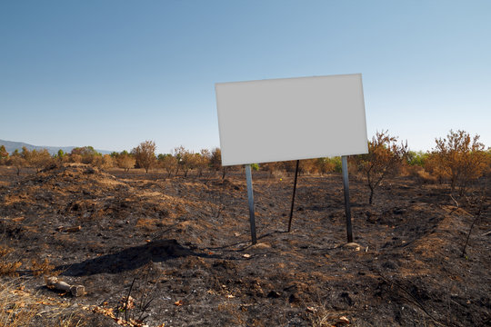Blank billboard in fire soil