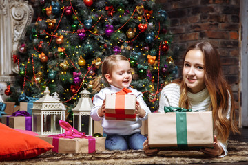 Fototapeta na wymiar Happy young mother and daughter with Christmas gifts