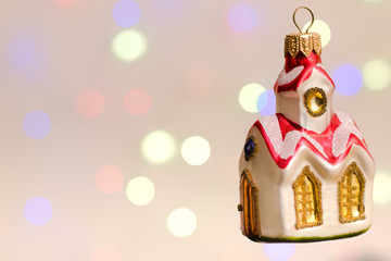 Beautiful christmas house on christmas lights background holidays celebration concept.