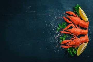 Lobster. Seafood. On a wooden background. Top view. Free space for your text.