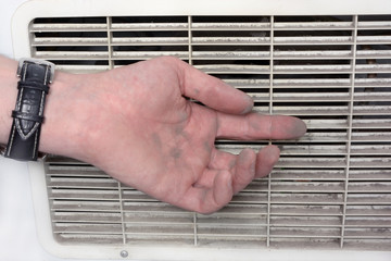 Person checks the contamination of the ventilation grate