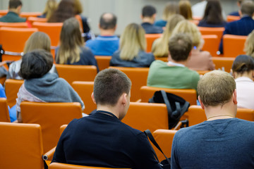 Audience listens to the lecturer at the conference hall