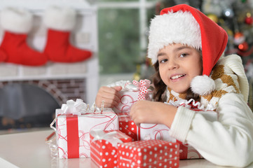  girl in Santa hat with gifts