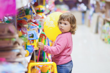 Toddler kid shopper at the toy shop.