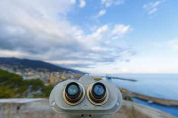 An old binoculars pointing on the city