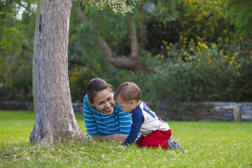 Fototapeta premium A mother and her baby are playing in a garden