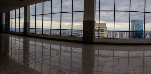 Front view of unfurnished contemporary interior, panoramic city view and daylight