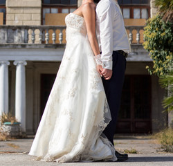 Happy bride and groom at wedding walk in park