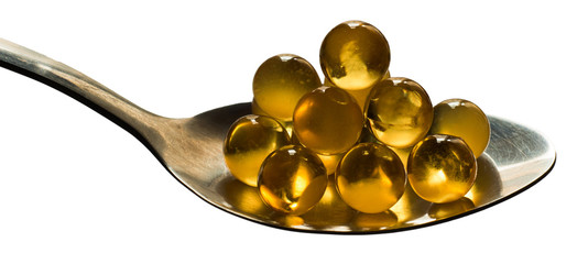 Spoon with cod liver oil isolated on white background