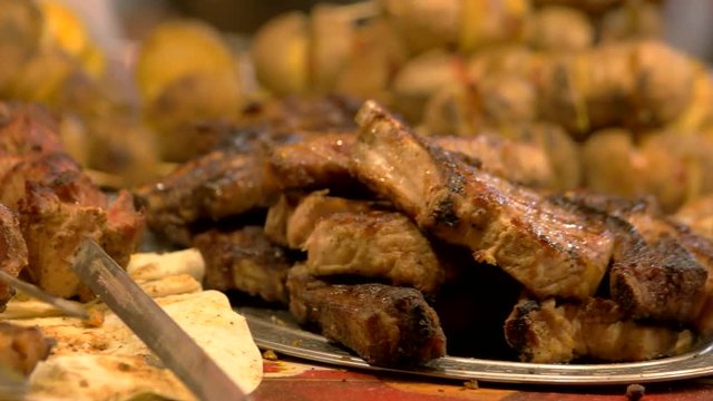 Shashlik and steak. Cooked meat close up.