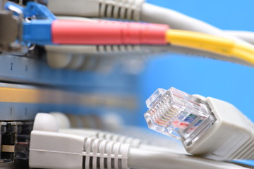 Network cables and server in datacenter, closeup