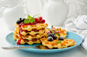 Belgian waffles with berries and raspberry topping