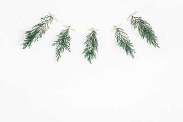 Christmas garland made of cypress branches on white background. Christmas, winter concept. Flat lay, top view, copy space