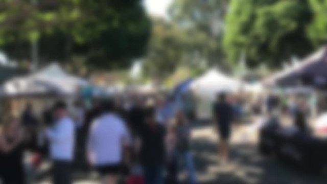 Blurred street fair with many people and crowds