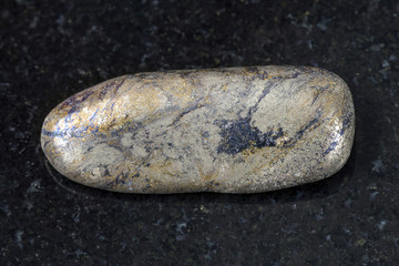 pebble of Arsenopyrite stone on dark background