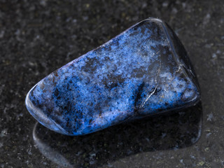 polished dumortierite gem on dark background