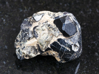 rough Spinel crystal on black Diopside crystals
