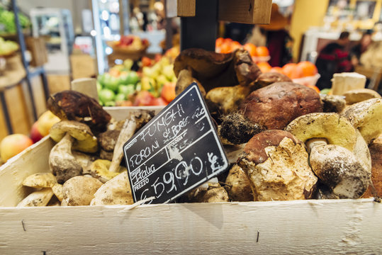 Funghi Porcini is a type of mushroom in Italy. Sign written in Italian is pointing towards price and location of product